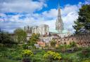 The spire of Chichester Cathedral dominates the skyline.