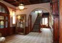 The hall at Balmoral House, where with light pours in from the impressive stained glass windows .