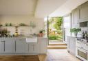 The kitchen units were handmade by Woodchester Cabinet Makers and hand-painted in a RAL version of Farrow & Ball’s Hardwick White. An old door and window
were converted into double-glass doors