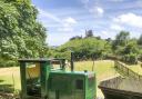 Reconstruction of the narrow-guage railway with train and waggons that used to transport the ball clay, with Corfe Castle in the background. (Photo: Purbeck Mining Museum)