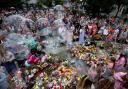 Children blow bubbles at a vigil in Southport.