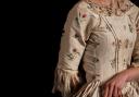 A late 18th century silk and floral embroidered open dress.