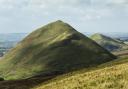 Dufton Pike and Knock Pike seen from the Pennine Way
on the route to High Cup. The conical shape of these hills is
due to their formation 480 million years ago from volcanic ash and slate (c) Helen Shaw