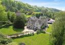 Greenhouse Court is approached via a sweeping driveway, leading to a twin-gabled frontage with a handsome battlement parapet entrance