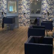 The salon looks smart and stylish with a feature wall and new lighting scheme