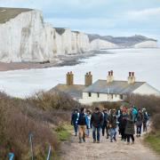 Pass by the iconic Coastguard Cottages on Walk the Chalk. Alex Franklin