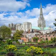 The spire of Chichester Cathedral dominates the skyline.