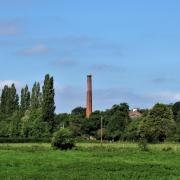 The red brick chimney of Coldharbour Mill commands the view