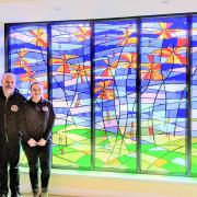 Andrew and Katie with the Derian House window