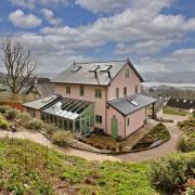 Claremont, Bishopsteignton. Built in 2021 with excellent eco credentials this spacious family house is in an elevated setting with wonderful estuary views.