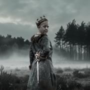 Belinda Harward Woolton as Lady Macbeth, with the woods of Brownsea Island behind.