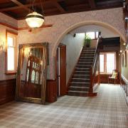 The hall at Balmoral House, where with light pours in from the impressive stained glass windows .