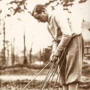 Sir Thomas Henry Cotton, English professional golfer who won three Open Championships, seen here on a golf course checking his clubs and putters, circa 1930s.