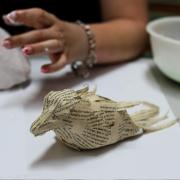 The Mendip Bird project with feathers from the pages of a book