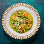 Gnocchi, served on a creamy herby pea sauce, a hazelnut pesto and garnished with pea shoots and the 'cheese with no name'