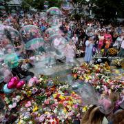 Children blow bubbles at a vigil in Southport.