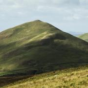 Dufton Pike and Knock Pike seen from the Pennine Way
on the route to High Cup. The conical shape of these hills is
due to their formation 480 million years ago from volcanic ash and slate (c) Helen Shaw