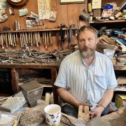 Silversmith Julian Hart, surrounded by tools his great grandfather George Hart would have used 100 years ago