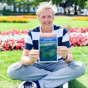 Mark Cummings with his new book in Imperial Gardens, Cheltenham