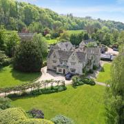 Greenhouse Court is approached via a sweeping driveway, leading to a twin-gabled frontage with a handsome battlement parapet entrance