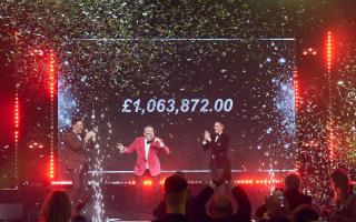 Michael makes the announcement at his 2023 charity ball, with his husband Lindon Kellett (right) and ball host Darren Proctor cheering him on. (c) The Vain Ltd - Carl Sukonik