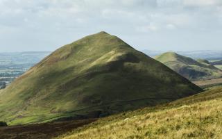 Dufton Pike and Knock Pike seen from the Pennine Way
on the route to High Cup. The conical shape of these hills is
due to their formation 480 million years ago from volcanic ash and slate (c) Helen Shaw