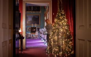 Decorating the tree in the Ante Room at Stourhead. Photo: National Trust, Steven  Haywood